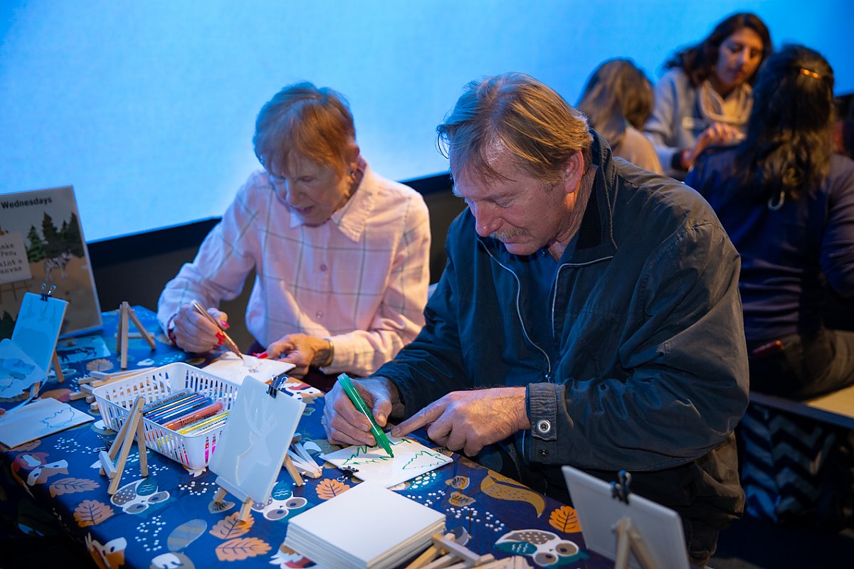 Man and woman at craft table drawing