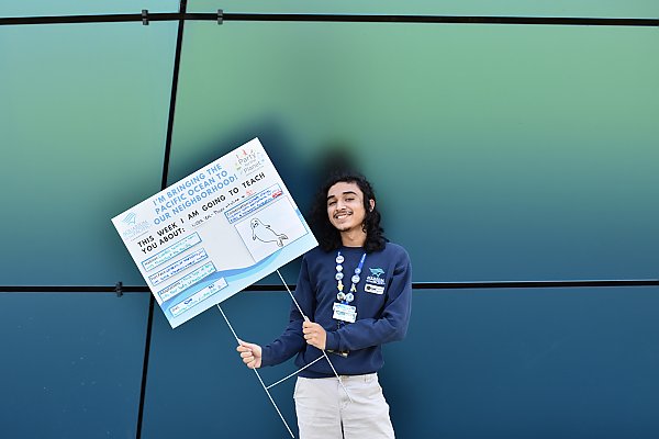 Person holding a home-made Ocean Neighbors sign about seals